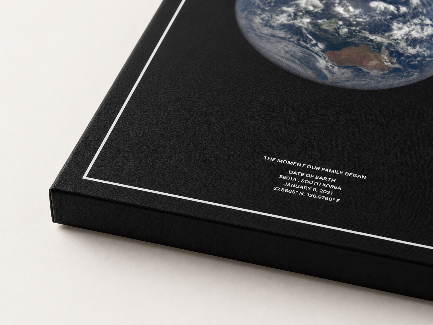 Close view of a black Date of Earth canvas print showing its textured edge.