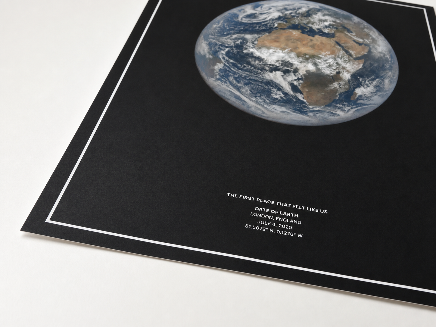 Close view of a black Date of Earth print on fine art paper.